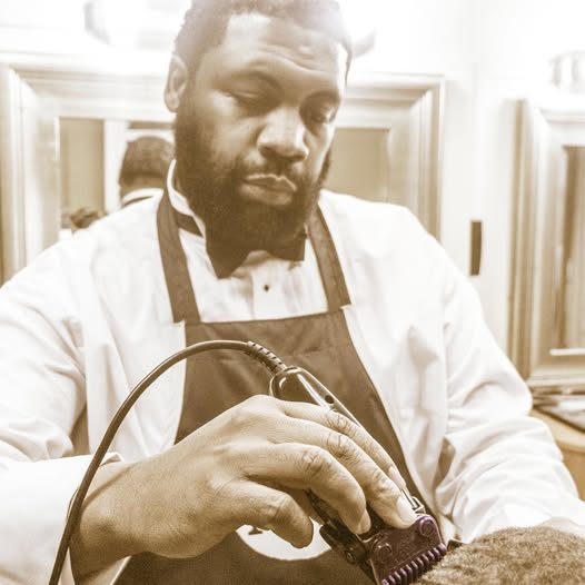 A barber at work at NewMan Barber Salon